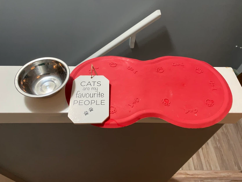 Cat food bowl, mat and sign