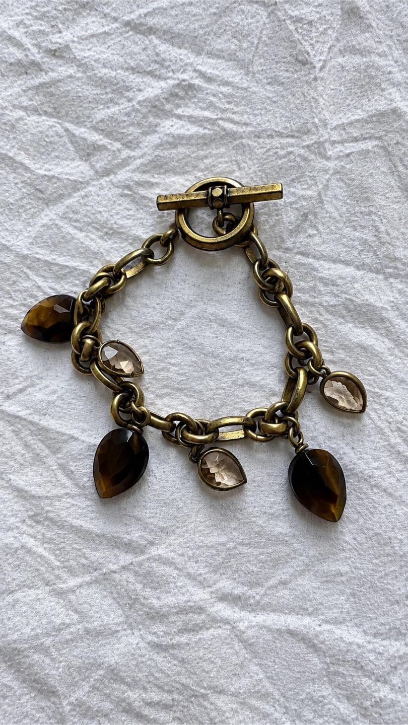 Gold tone charm bracelet with dark and clear stones - photo 2