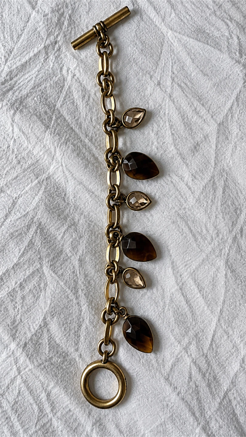 Gold tone charm bracelet with dark and clear stones - photo 3
