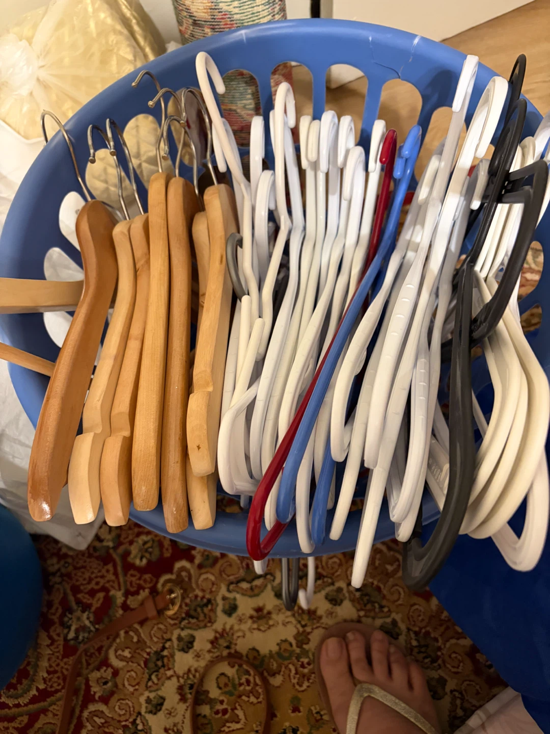 Assorted Clothes Hangers in Blue Basket