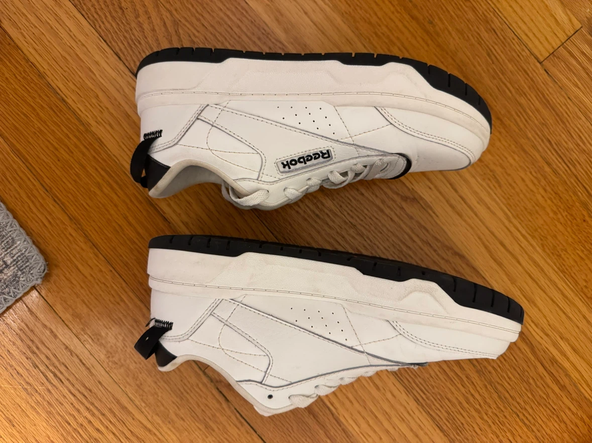 White and black womanly Reebok shoes