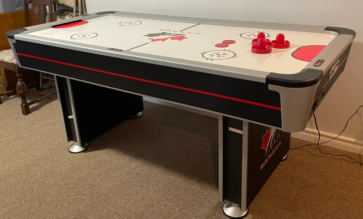 Air hockey game table with electronic scoreboard