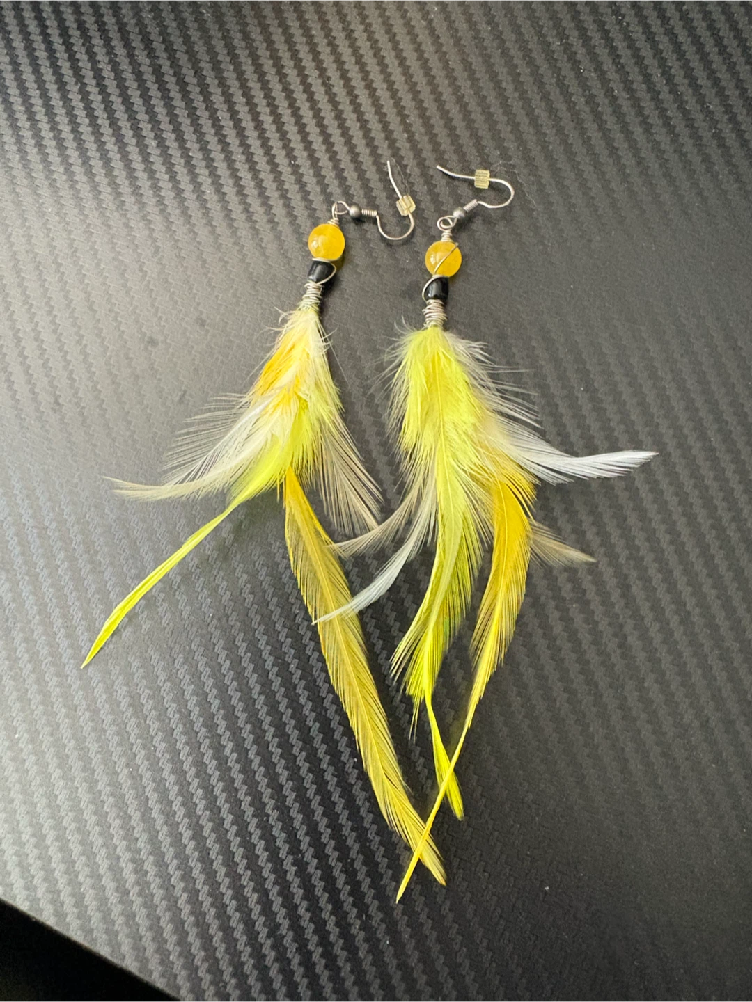 Yellow feather dangle earrings