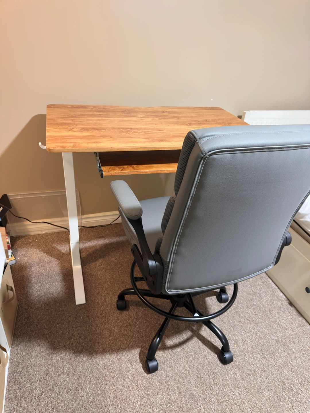 Grey swivel chair, and electric desk