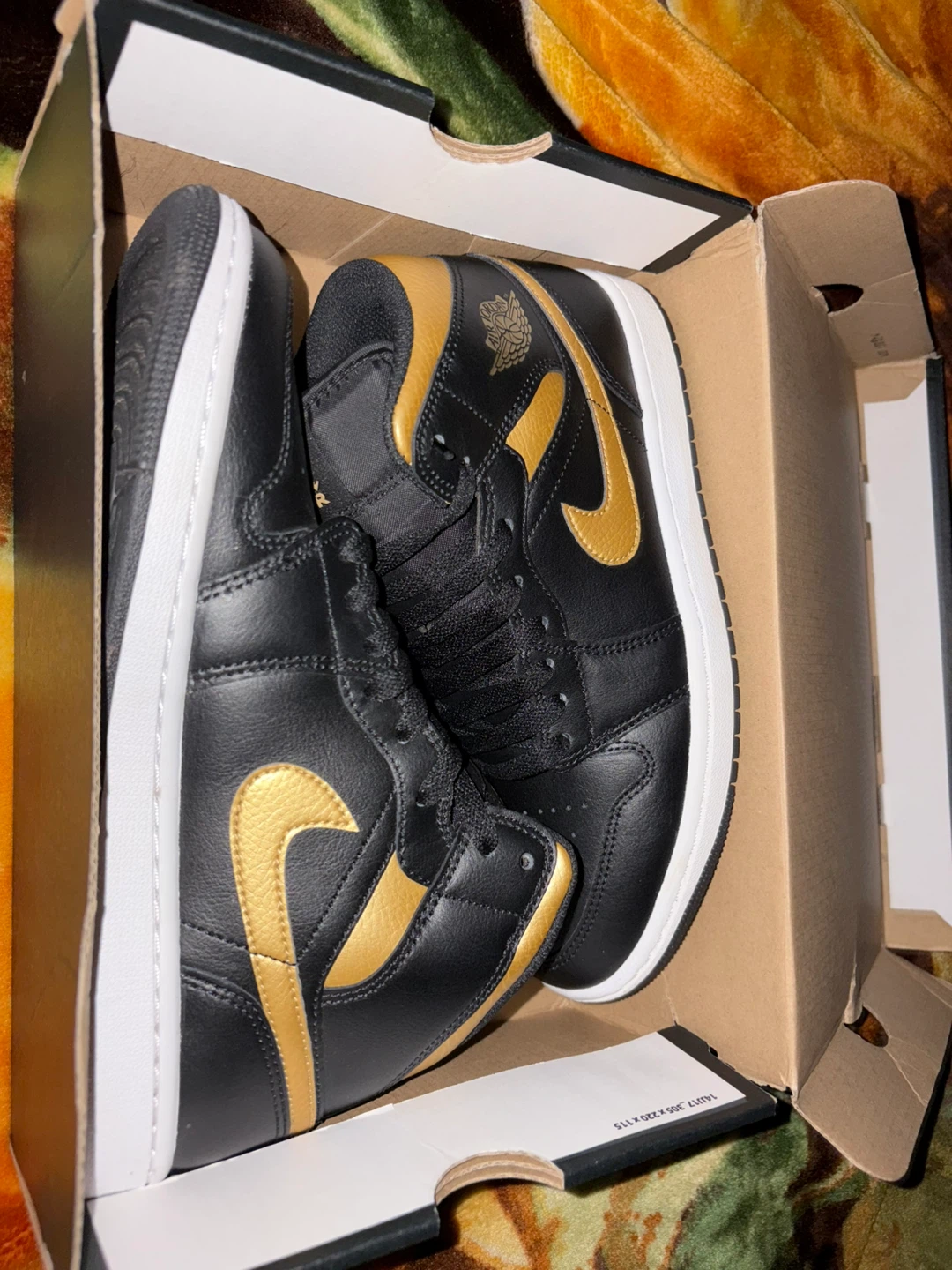Air Jordan 1 Mid Black and Gold Sneakers
