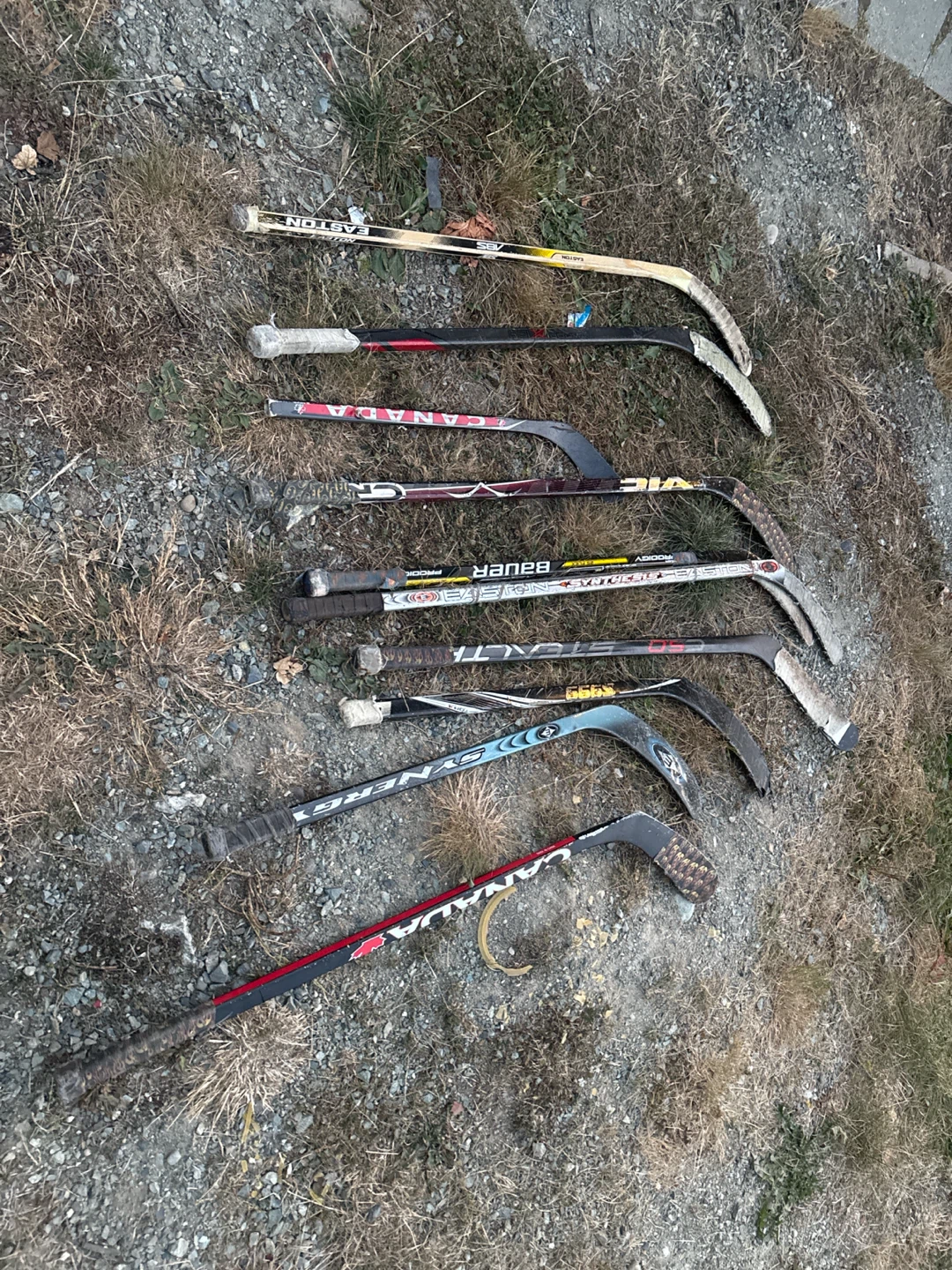 Assorted Hockey Sticks and Plastic Bucket