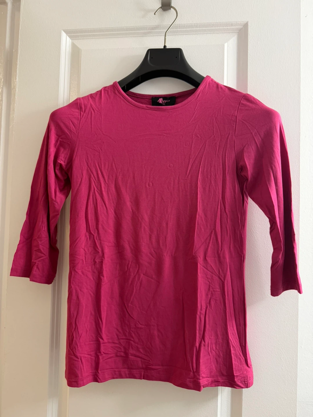 Naya's pink long-sleeve top