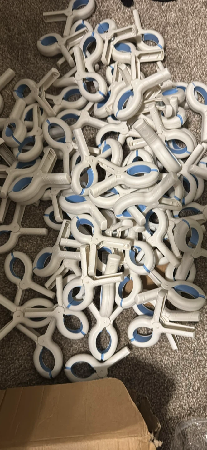 Large set of 84 white plastic utility clamps