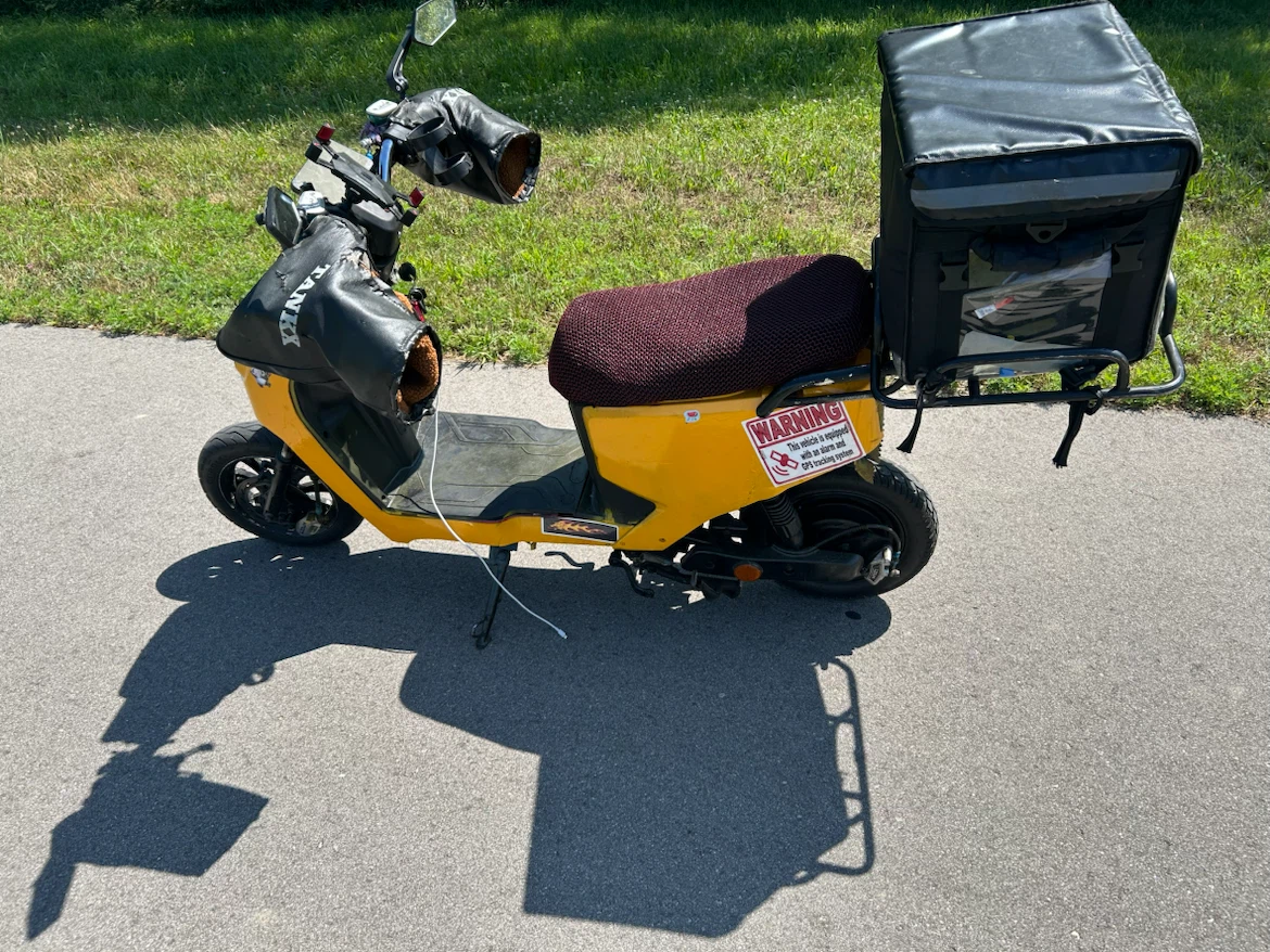 Yellow electric scooter with delivery box