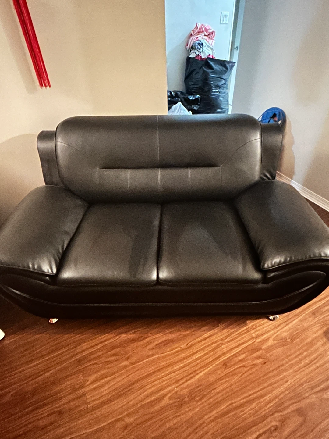 Black faux leather loveseat and a single sofa - photo 2