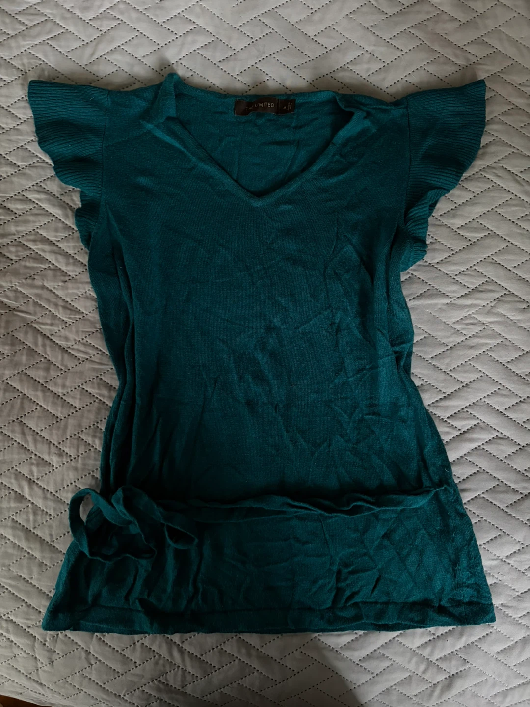 Turquoise top with a wrap-around belt detail