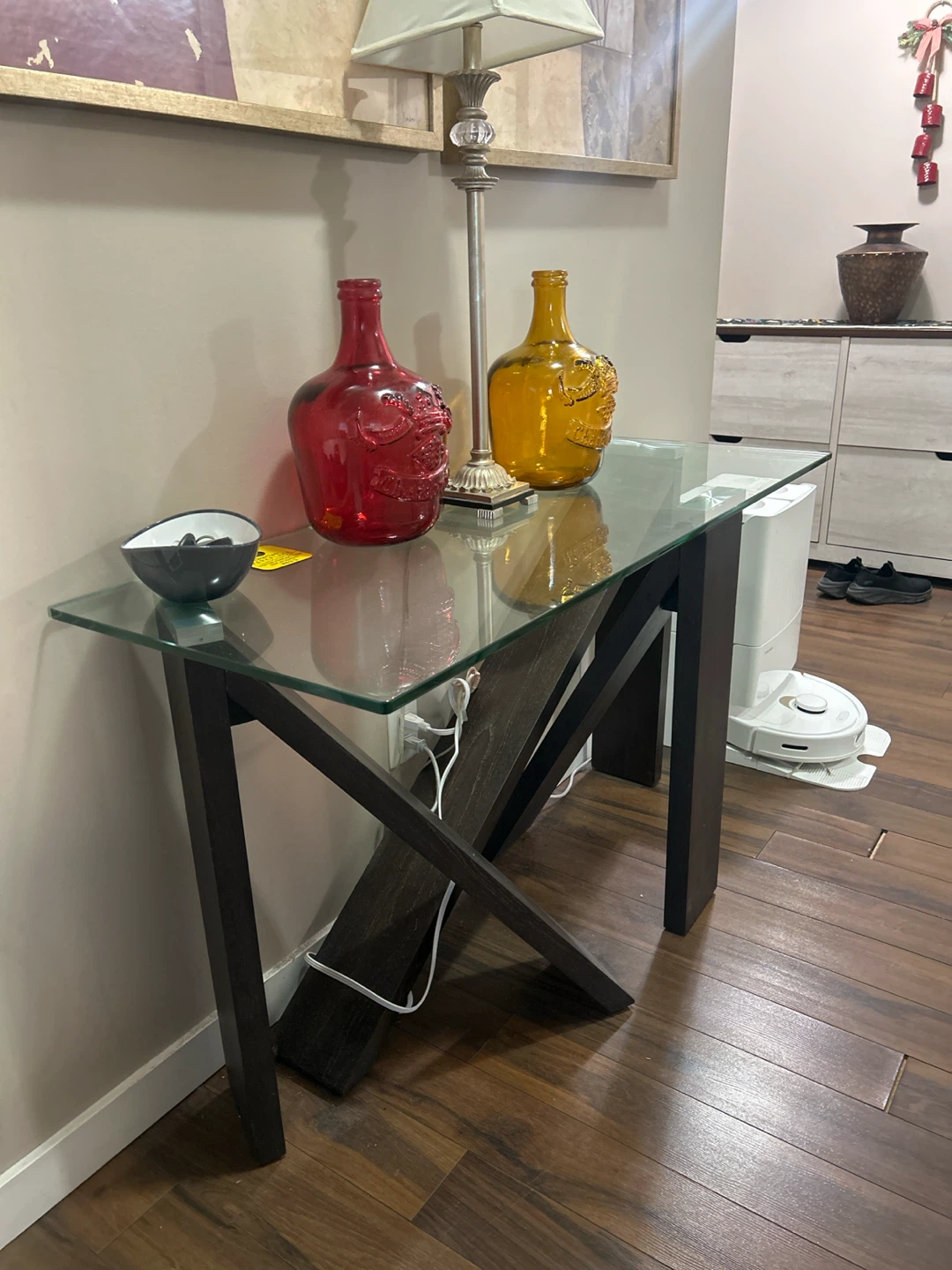 Glass top console table with dark wood frame