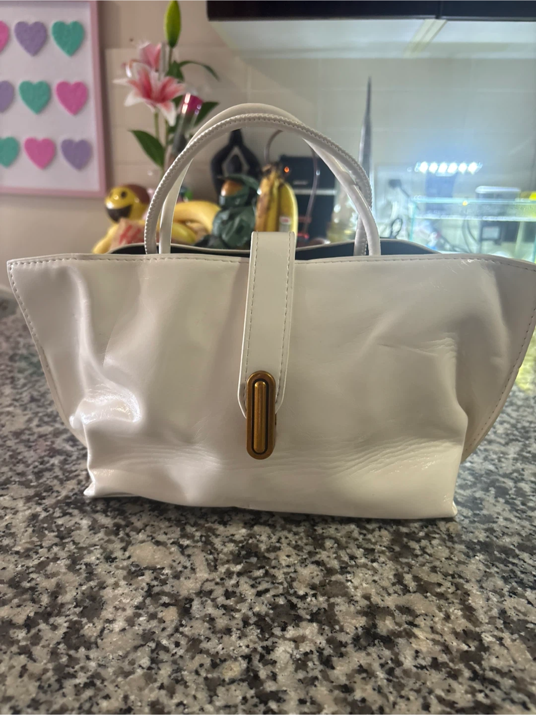 White handbag with gold-tone hardware