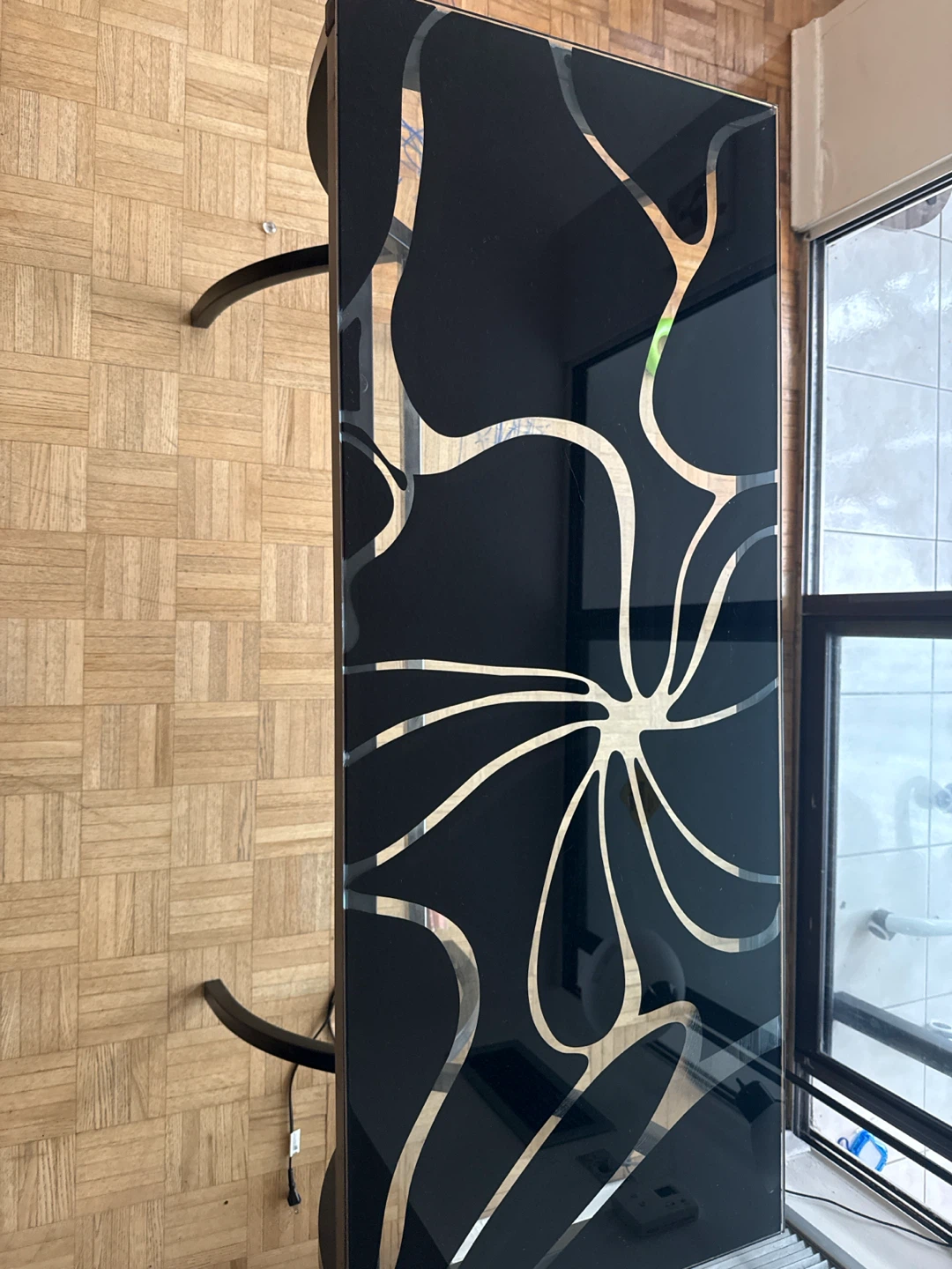 Modern black glass console table with floral design
