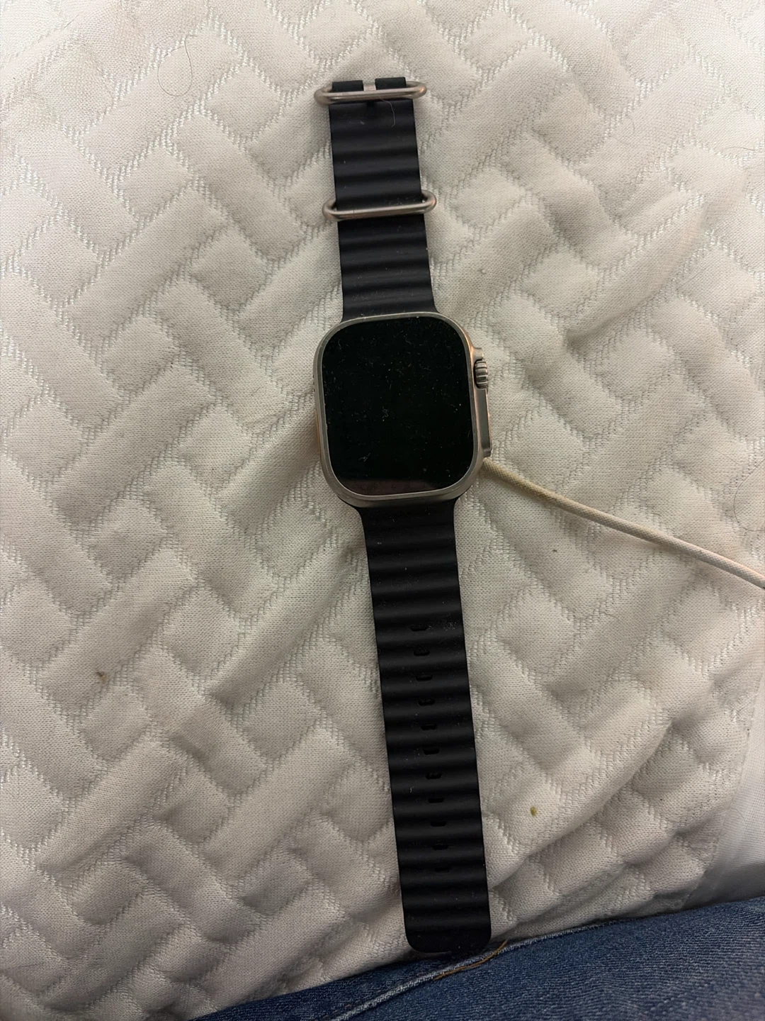 Apple Watch Ultra with black band + charging cord