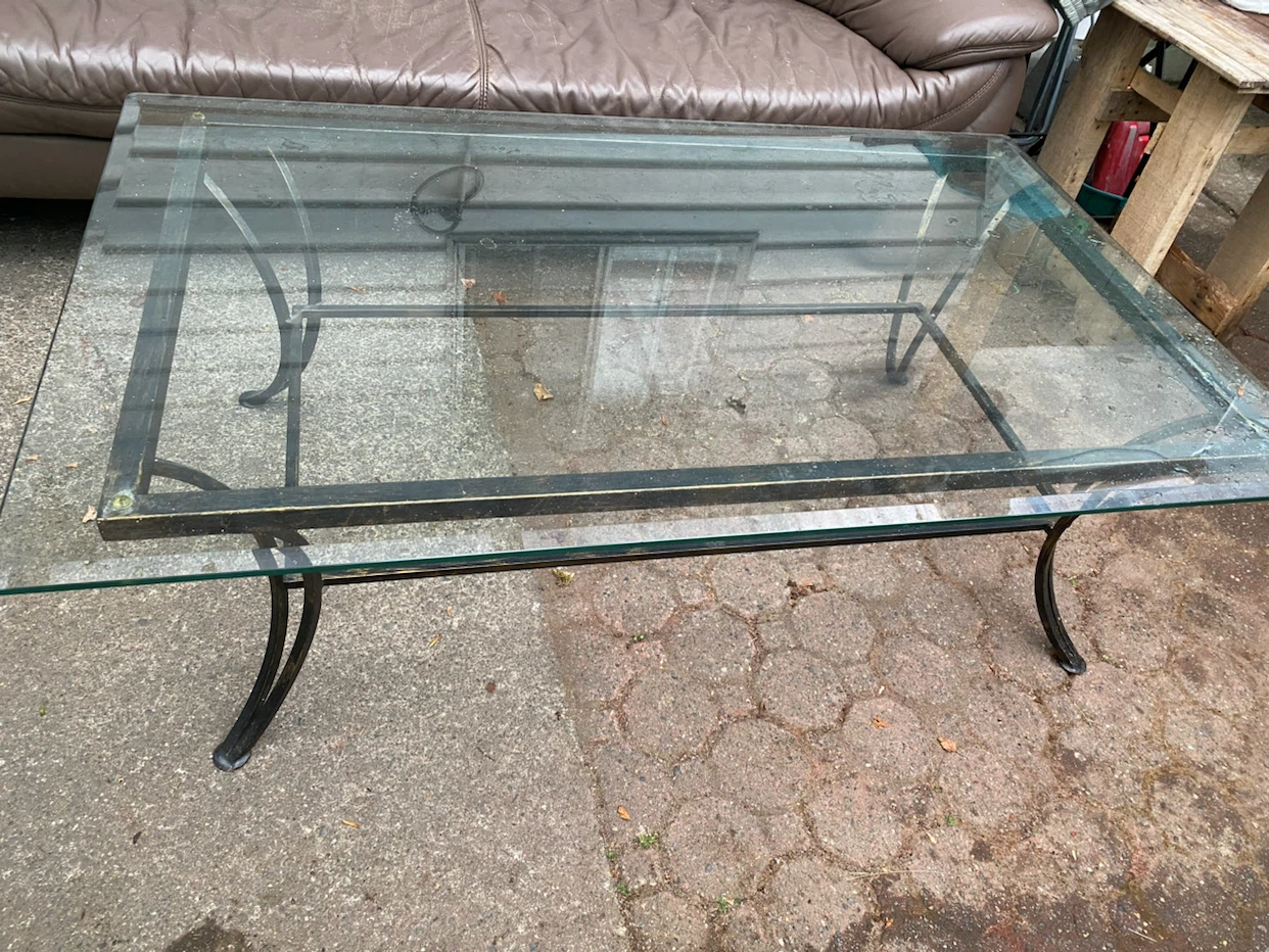 Glass top coffee table with black metal frame