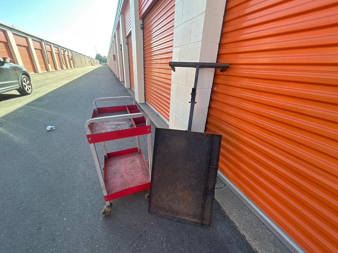 Rolling red utility cart with metal tray