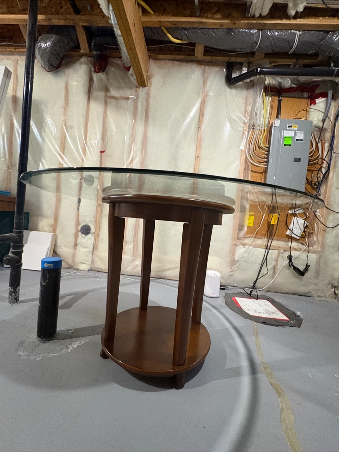 Round wooden side table with glass top