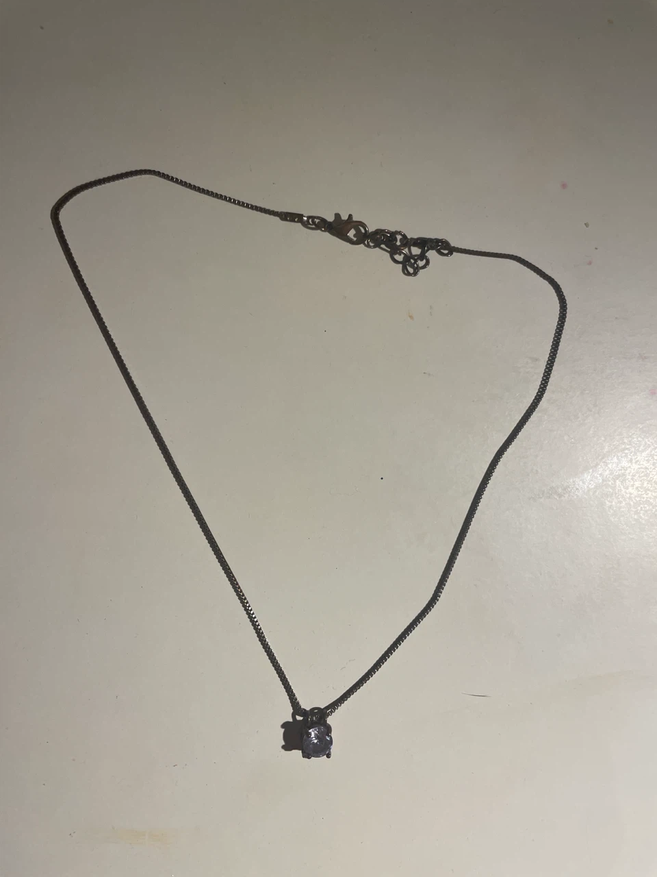 Black chain necklace with round stone pendant