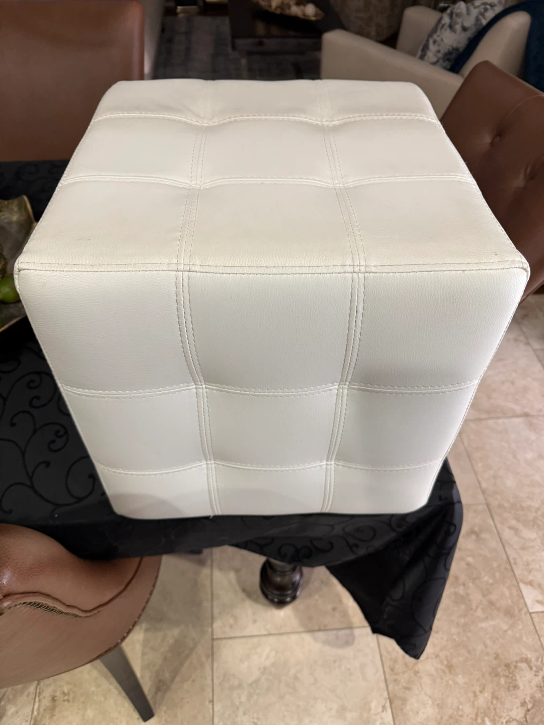 White tufted faux leather ottoman