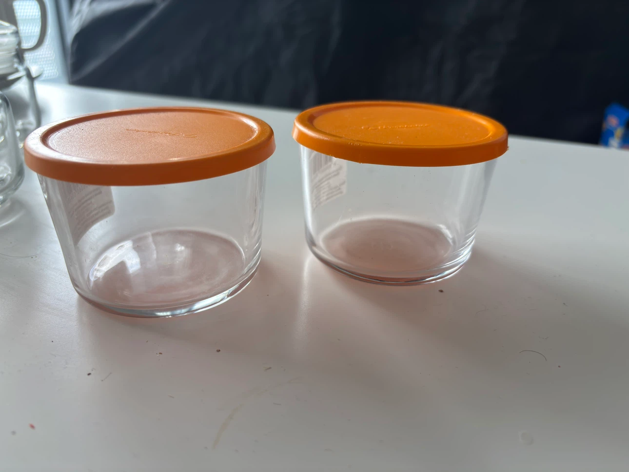 Two Tupperware Glass Containers
