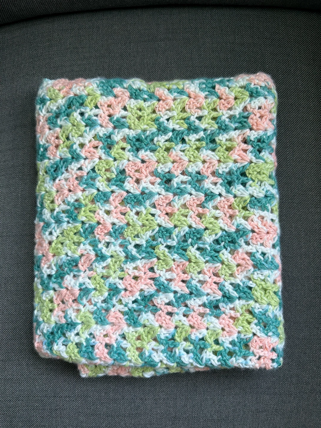 Hand-knitted multi-coloured baby blanket