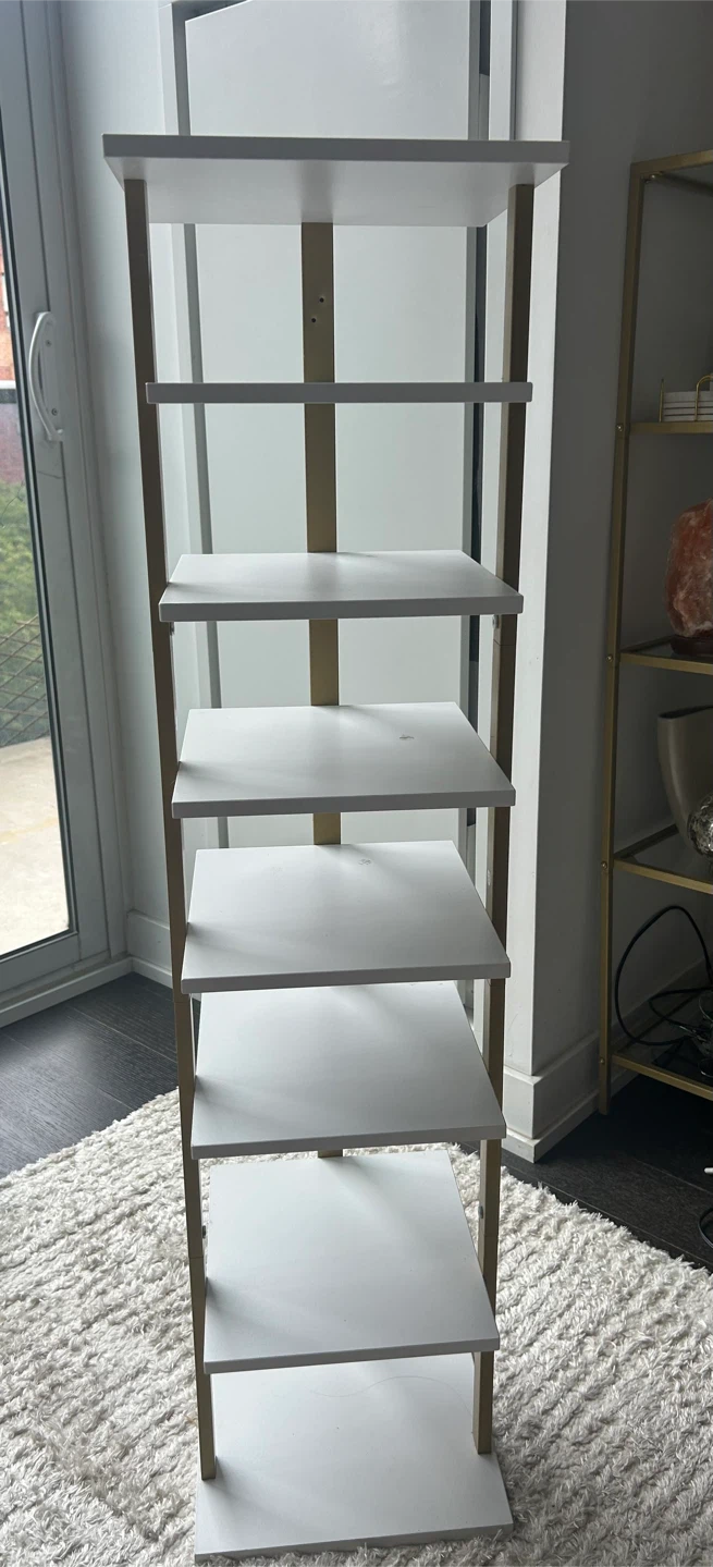 Tall white and gold storage shelf