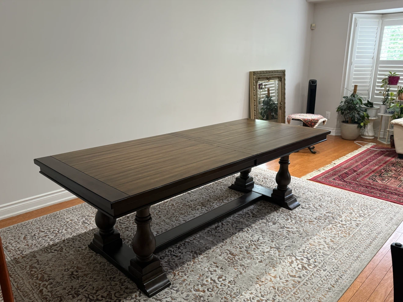 Large dark wood dining table with 8 chairs