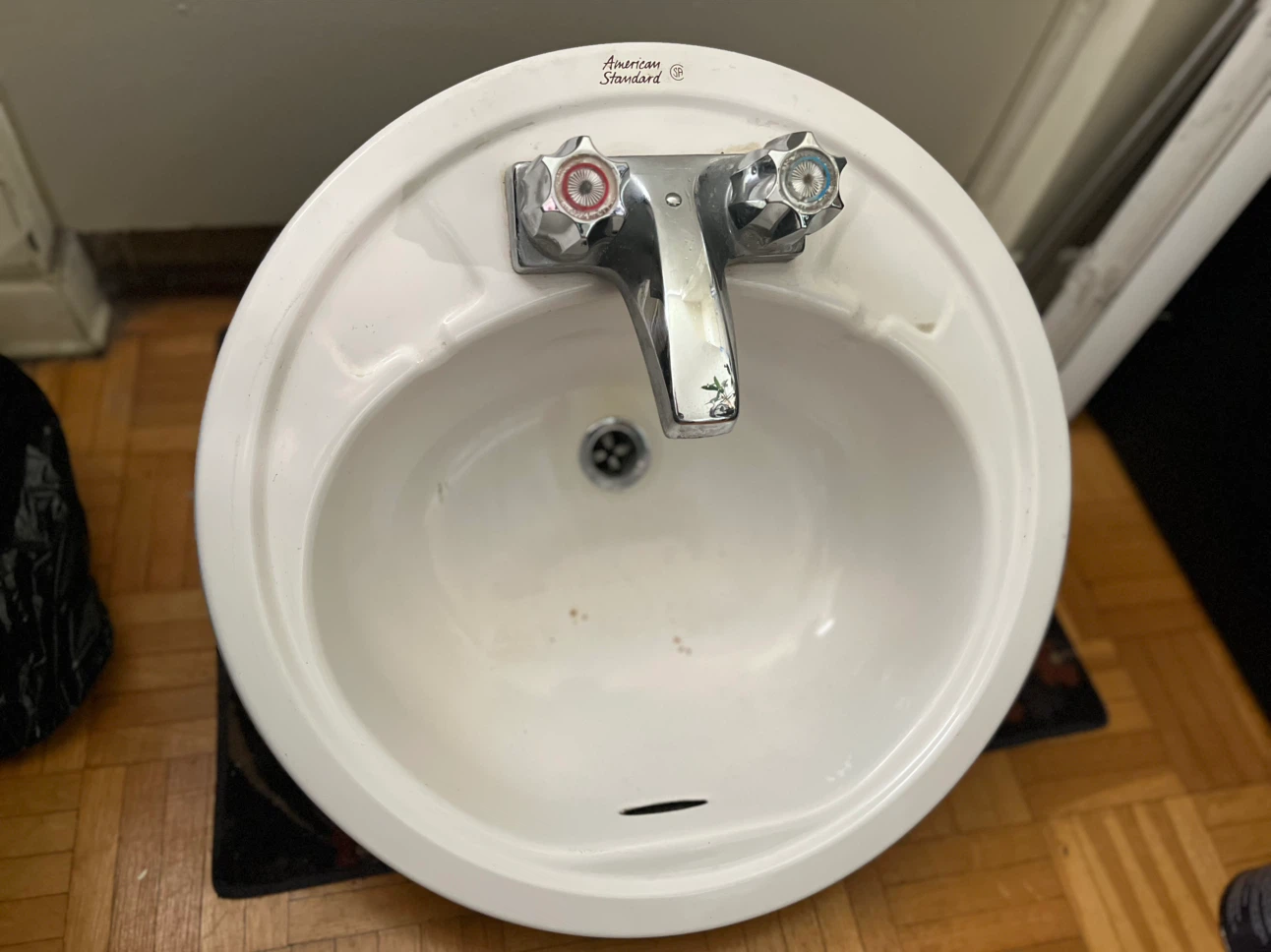 American Standard white bathroom sink with faucet