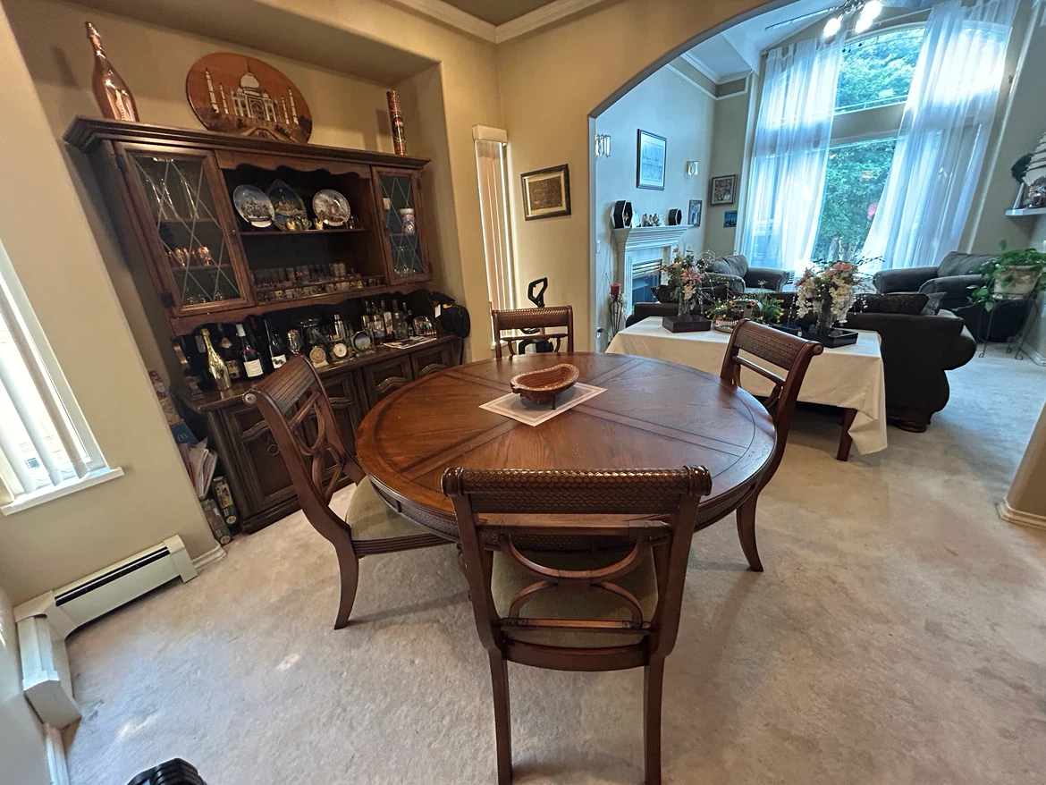 Round wooden dining table with four chairs