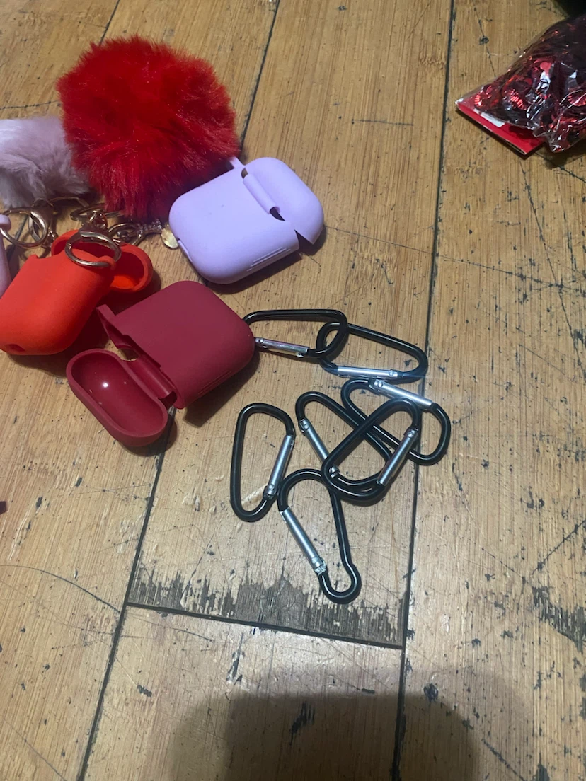 Assorted AirPod cases with hanging clips