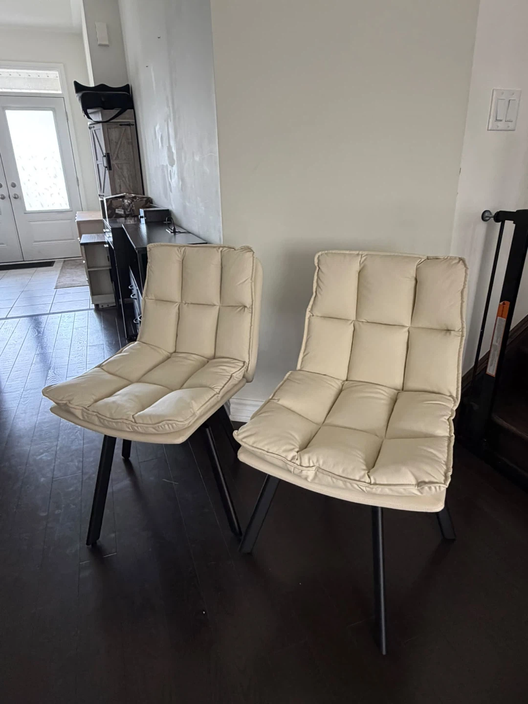 Two cream upholstered dining chairs