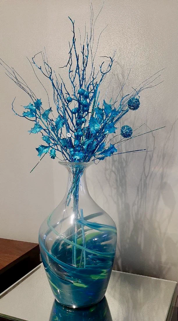 Blue decorative vase with floral arrangement