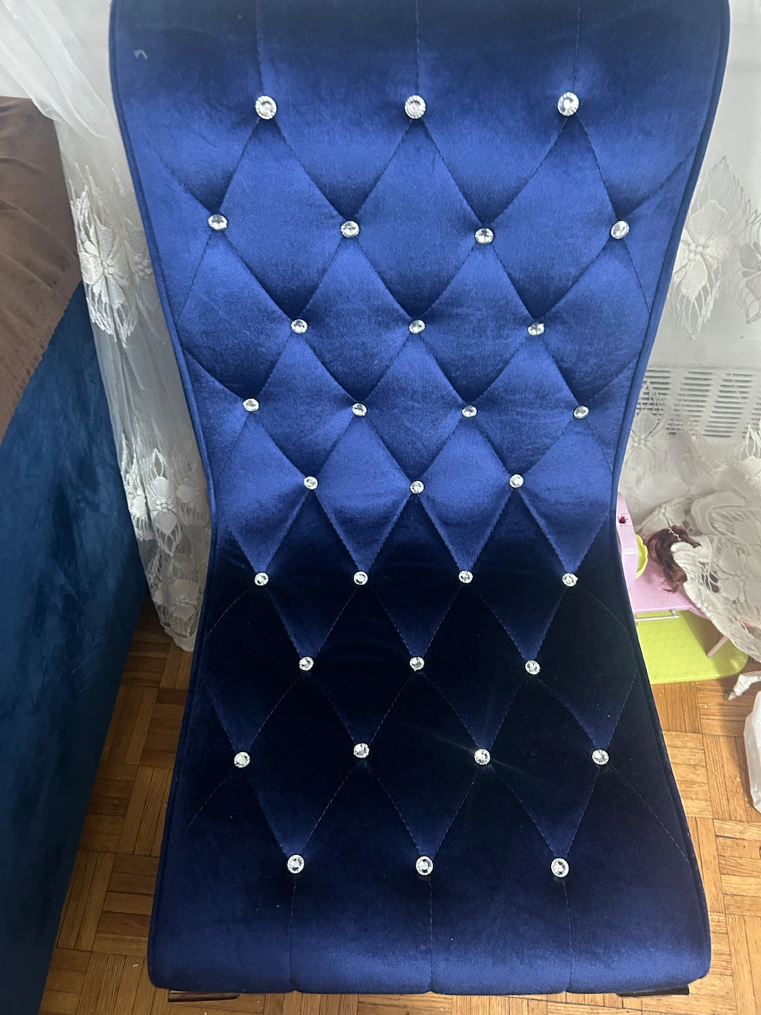 Blue velvet dining chair with crystal tufting