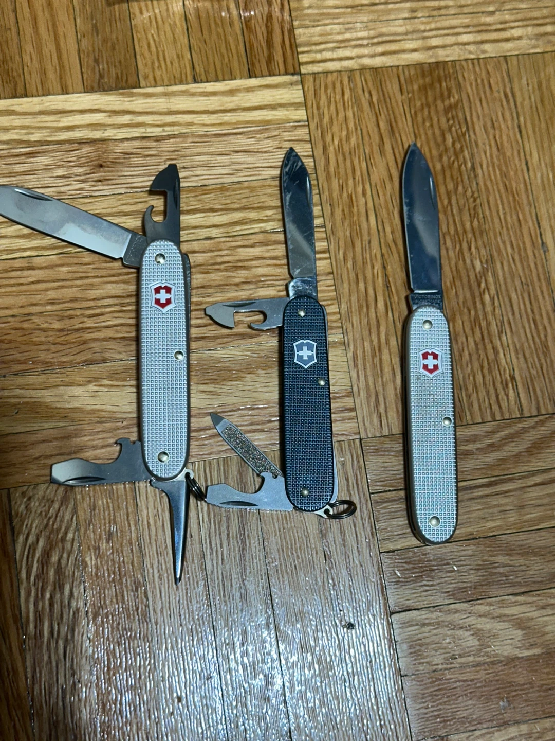 Three Victorinox Swiss Army Knives metal