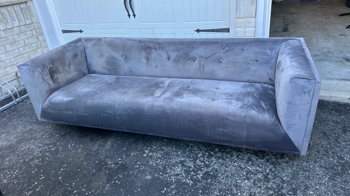 Grey velvet button-tufted sofa