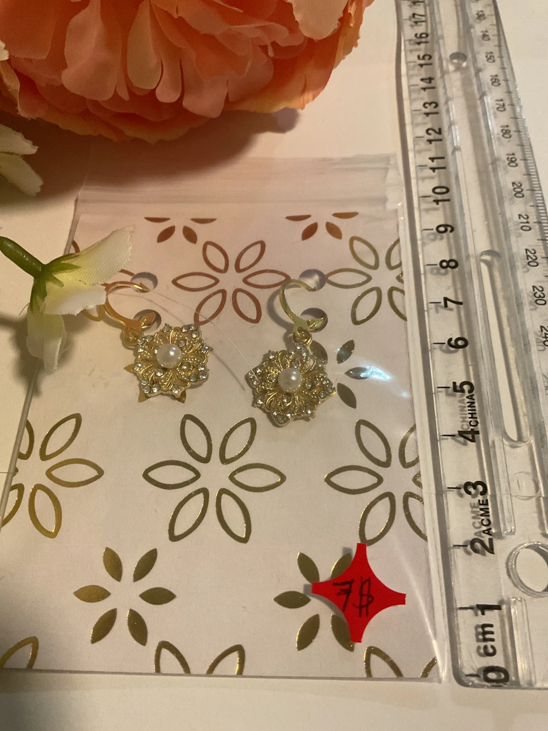 Gold-tone flower earrings with faux pearls