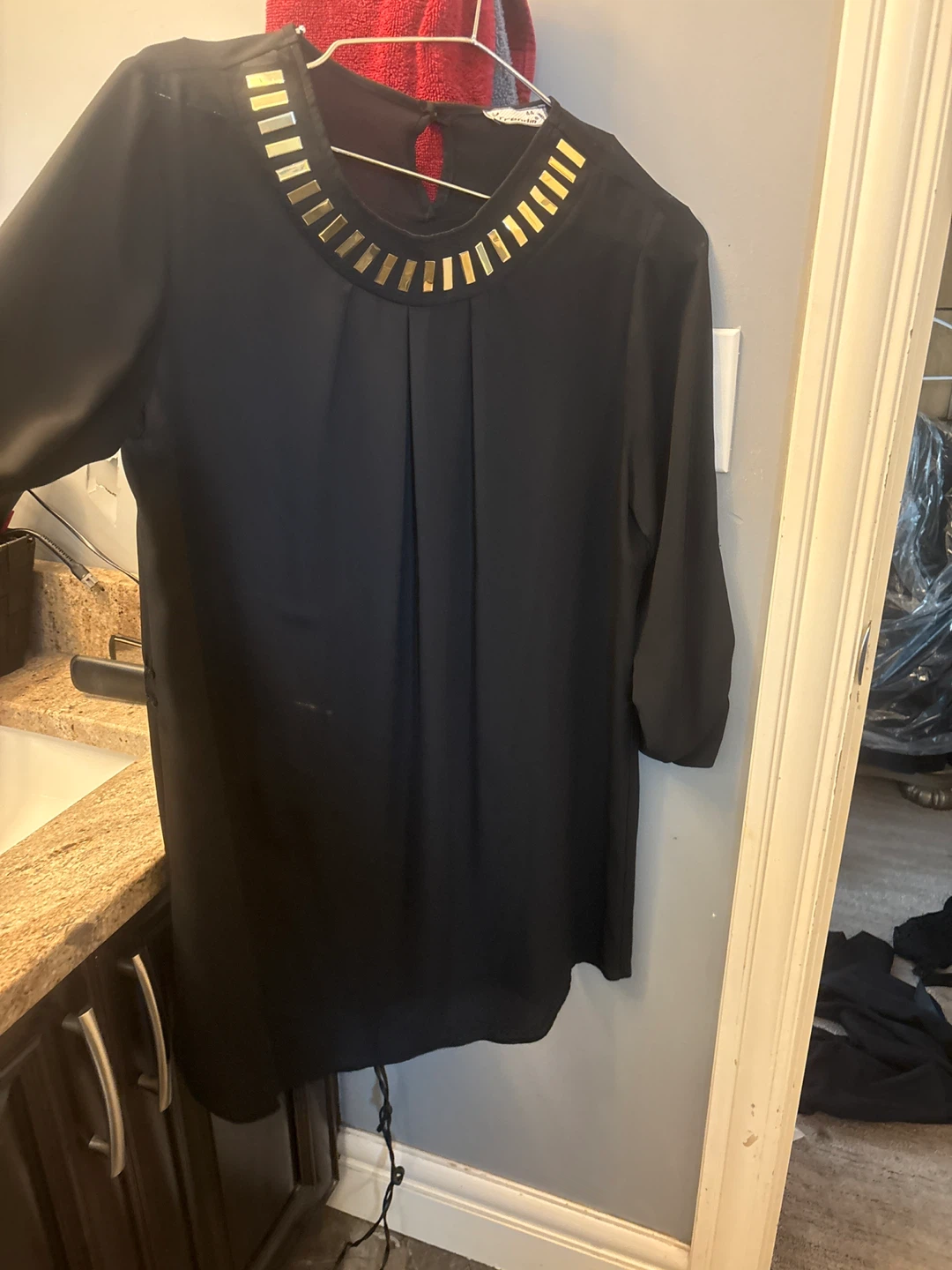 New Trendm black blouse with gold accents