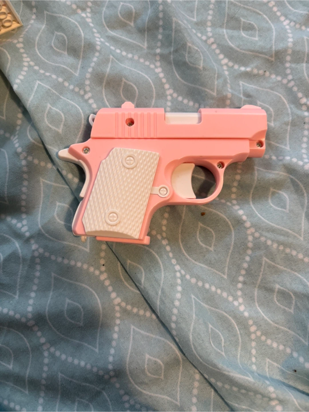 Pink and white toy pistol