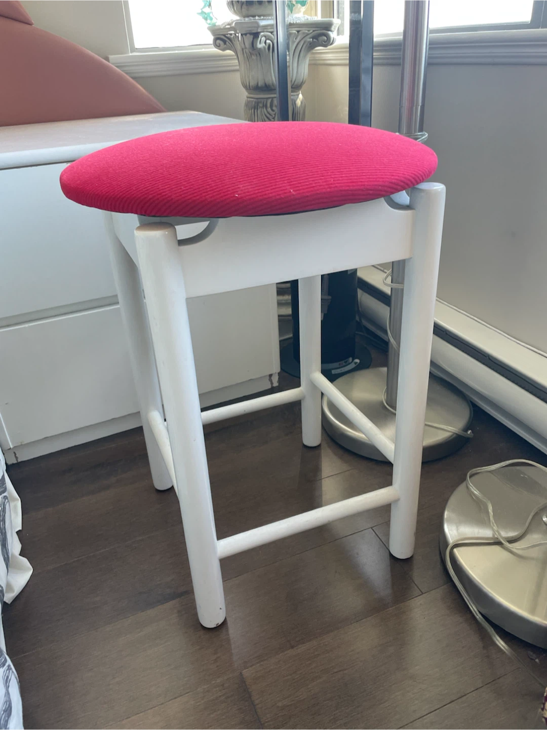 White stool with red circular seat