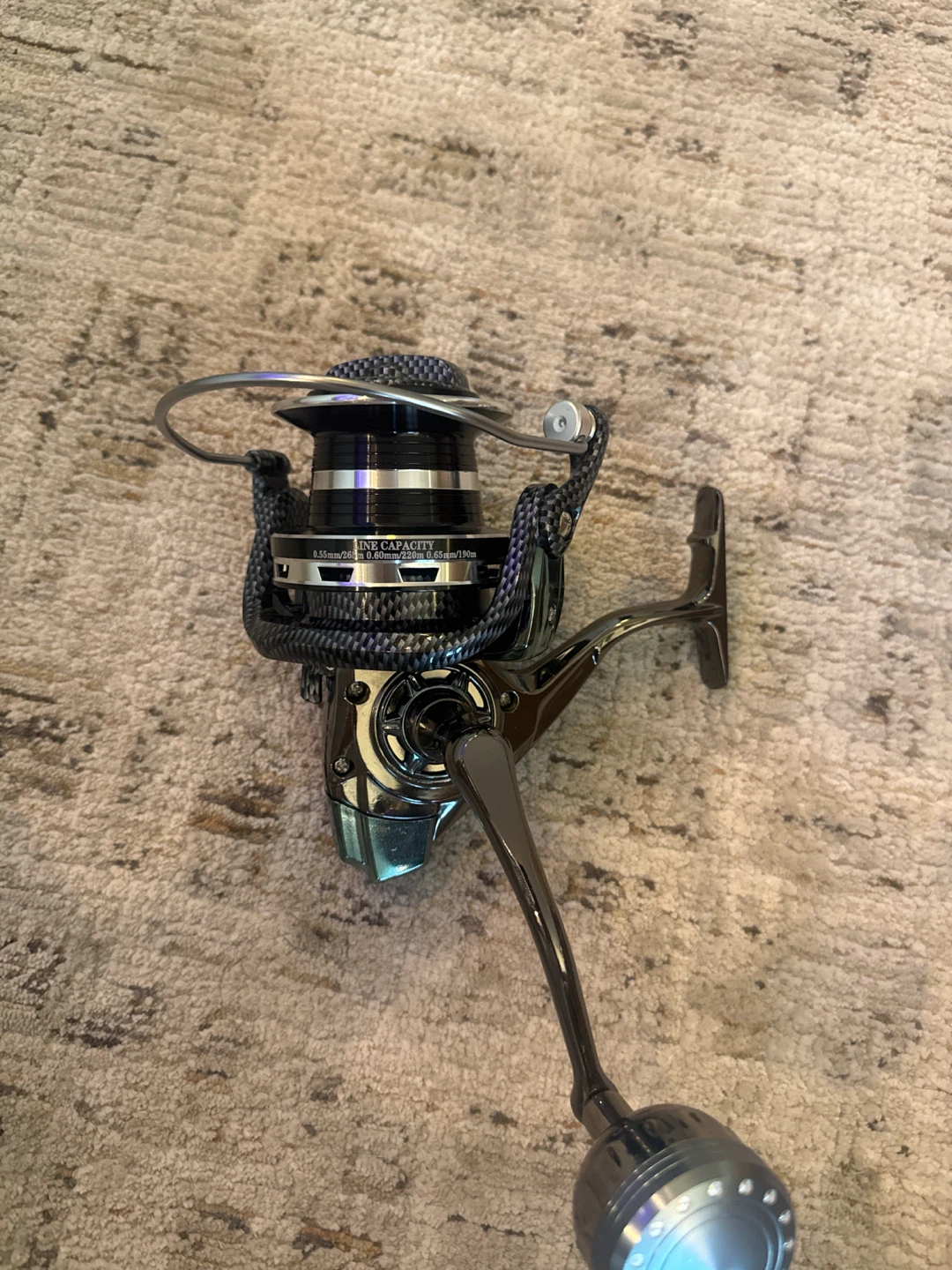 Never used DE12000 Carbon Finish Spinning Reel