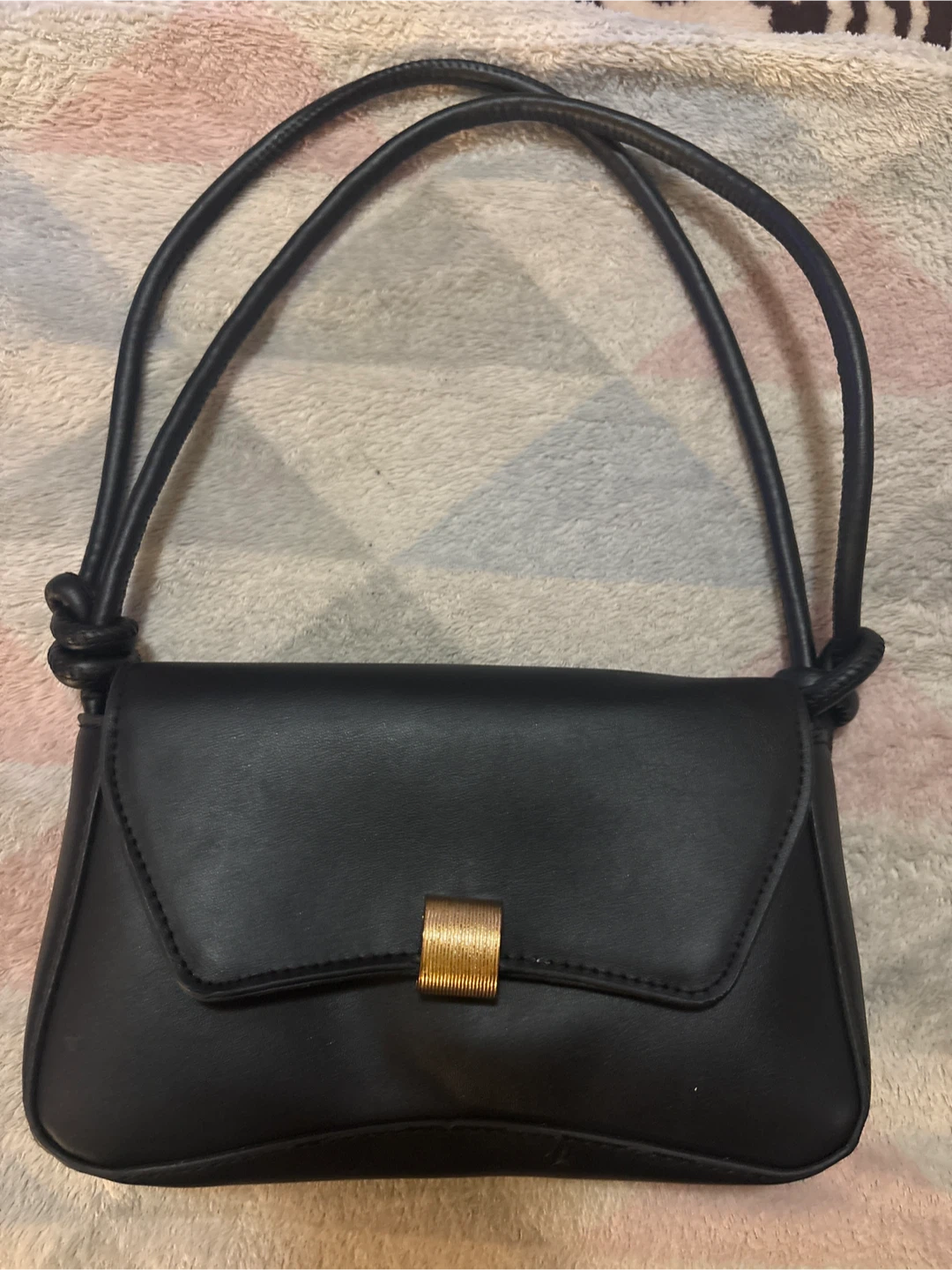 Black shoulder bag with gold hardware