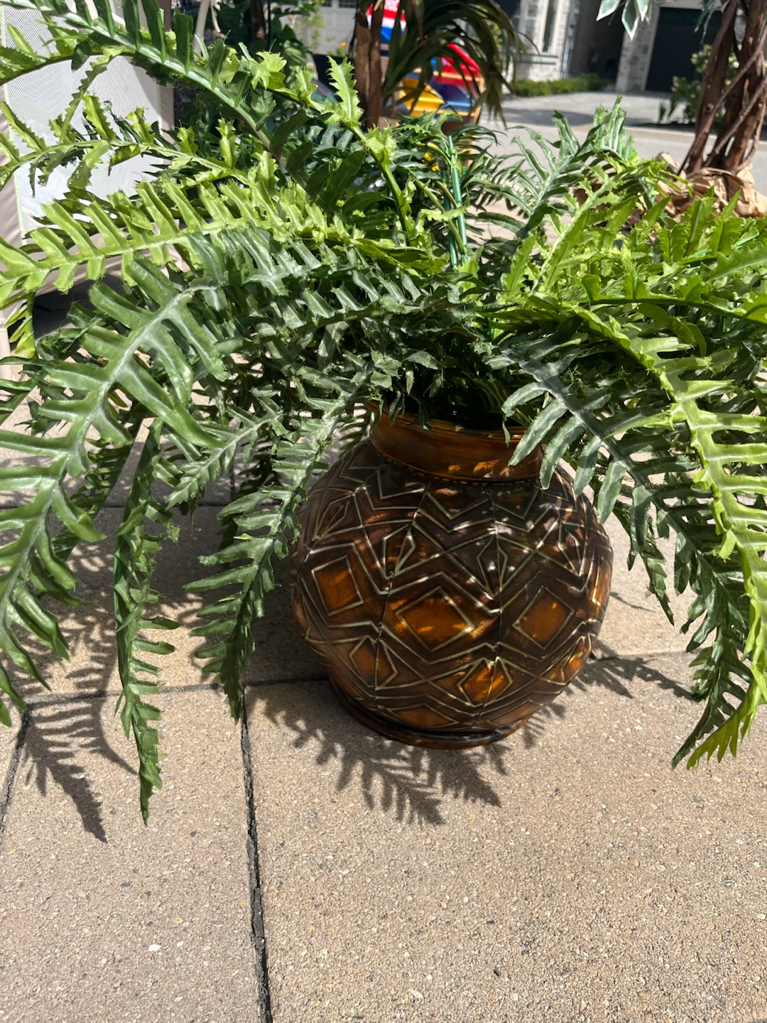 Artificial fern in geometric brown planter