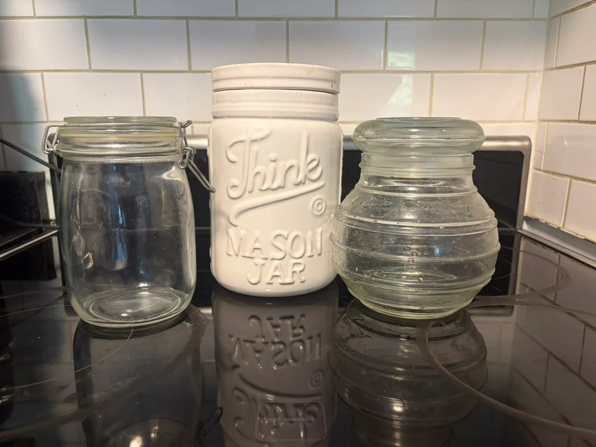Three assorted glass and ceramic storage jars