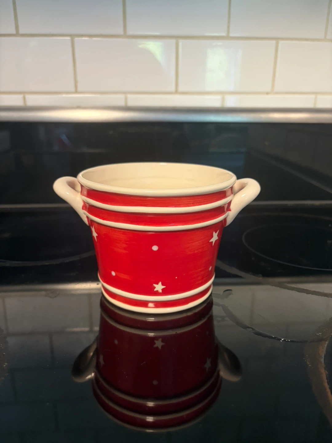 Red and white ceramic star motif bowl with handles