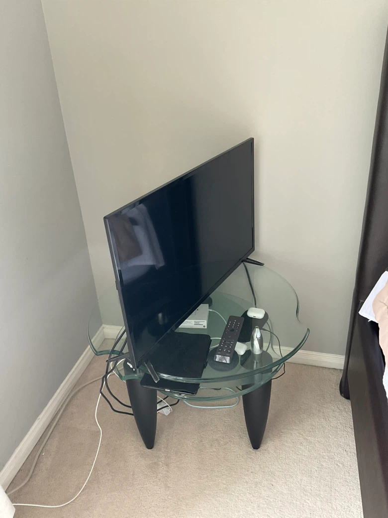 Glass top side table with black legs