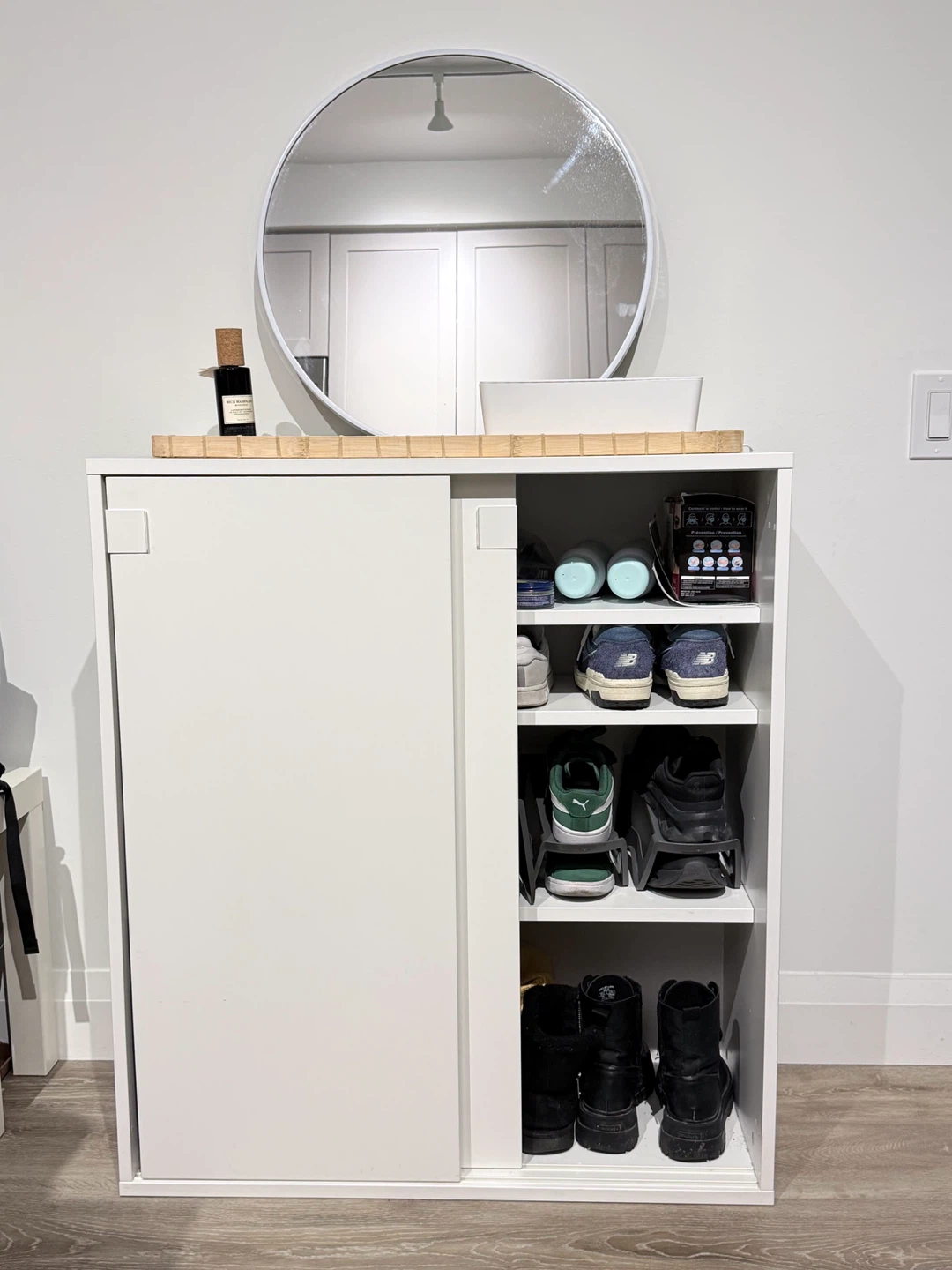 IKEA MACKAPÄR White sliding door shoe cabinet and a round mirror