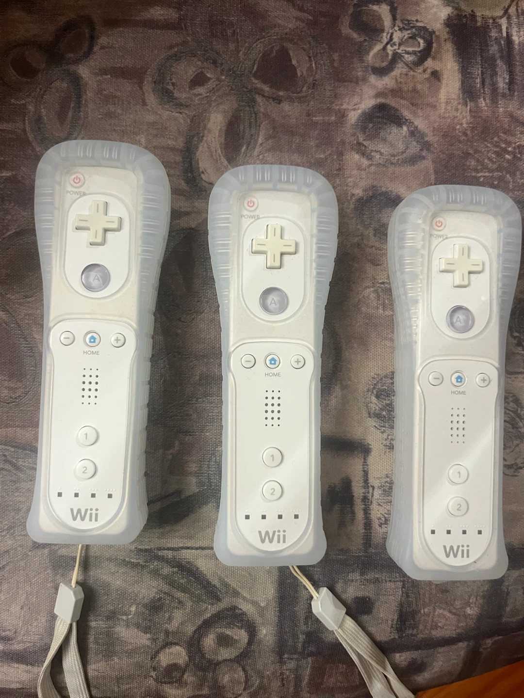Three Nintendo Wii Remote Controllers with Jackets
