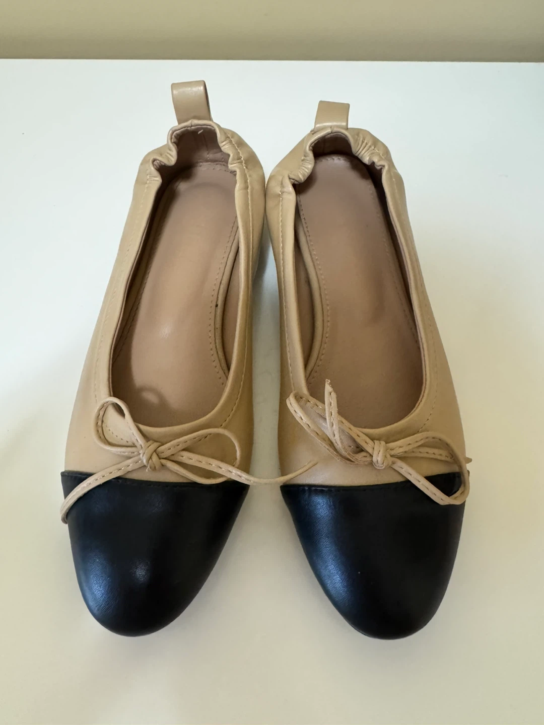 Two-tone beige and black ballet flats