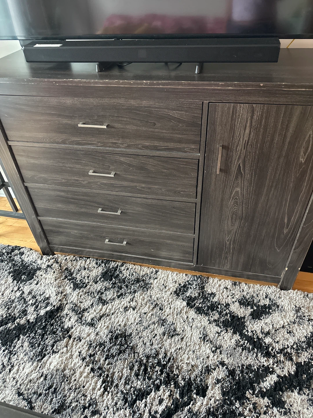 Dark wood dresser with four drawers and side cabinet